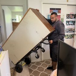 Island Wide Junk Removal Specialist - Styson removing one of the two dressers from the room.
