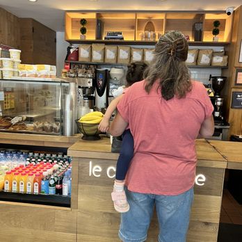 Le Café Coffee - a woman holding a child - Coffee & Tea Near Me - New York, New York Le Café Coffee - a woman holding a child - Coffee & Tea Near Me - New York, New York