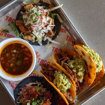 Taco Rock - (Clockwise from top) Greek taco, birria tacos, chili pork belly and consume for birria - Tacos Near Me - Alexandria, Virginia Taco Rock - (Clockwise from top) Greek taco, birria tacos, chili pork belly and consume for birria - Tacos Near Me - Alexandria, Virginia