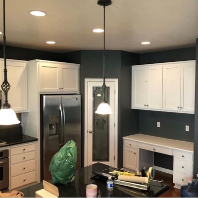 Interior kitchen walls and kitchen cabinets - This client wanted a more modern day kitchen, opening up the space making it look a little bigger with a more modern look. We painted the kitchen dark modern colors and transformed the kitchen cabinets from wood stained to pure white for a more modern look. Client was very happy with the results.
