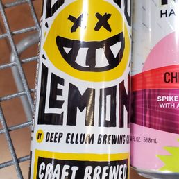 two cans of beer on a wire shelf