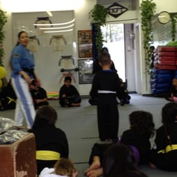 Ma'am giving instruction before judging sparring of the two children on the mat. Fun! Ma'am giving instruction before judging sparring of the two children on the mat. Fun!