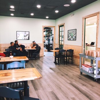 Sacred Beans - Seating area with roastery in the back. - Coffee Roasteries Near Me - Denver, Colorado
