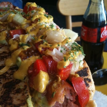 Dat Dog - Gator dog on sourdough, fully loaded. Cheese, onions, chili, guacamole, tomatoes, saurkraut, and mustard. - Hot Dogs Near Me - New Orleans, Louisiana Dat Dog - Gator dog on sourdough, fully loaded. Cheese, onions, chili, guacamole, tomatoes, saurkraut, and mustard. - Hot Dogs Near Me - New Orleans, Louisiana