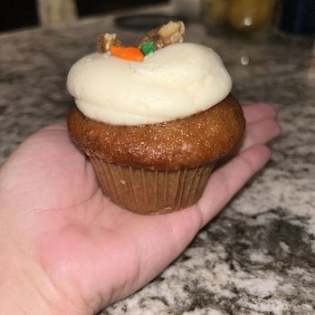Pink Elephant Cupcakes - a hand holding a cupcake - Desserts Near Me - Saint Clair Shores, Michigan Pink Elephant Cupcakes - a hand holding a cupcake - Desserts Near Me - Saint Clair Shores, Michigan