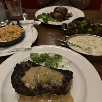 The Capital Grille - Bone-In Kona Crusted Dry Aged NY/KC Strip with Shallot Butter Lobster Mac 'N' Cheese Sam's Mashed Potatoes Soy Glazed Brussels Sprouts - Steakhouses Near Me - Columbus, Ohio The Capital Grille - Bone-In Kona Crusted Dry Aged NY/KC Strip with Shallot Butter Lobster Mac 'N' Cheese Sam's Mashed Potatoes Soy Glazed Brussels Sprouts - Steakhouses Near Me - Columbus, Ohio