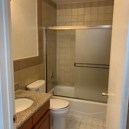 Old, ugly bathroom with icky brown tile from the '70s that does not match the cheap blue vinyl on the ground Old, ugly bathroom with icky brown tile from the '70s that does not match the cheap blue vinyl on the ground