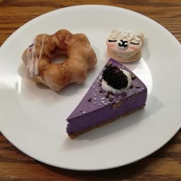 Mochi donut, macaron, and slice of ube cake Mochi donut, macaron, and slice of ube cake