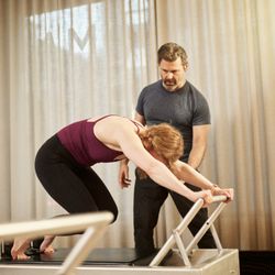 Vitality Method Studio - Teaching Knees Stretches on the classical Pilates Reformer