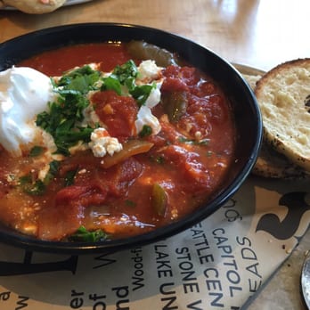 Eltana - Amazing shakshuka with poached egg. Garnished with parsley. - Coffee & Tea Near Me - Seattle, Washington Eltana - Amazing shakshuka with poached egg. Garnished with parsley. - Coffee & Tea Near Me - Seattle, Washington