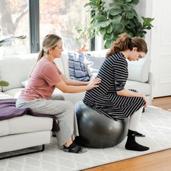 Connected Doulas - Birth doula provides counter pressure to a mother in labor