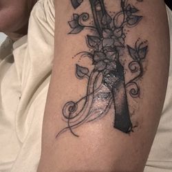 Jim's Tattoo Studio - A stiletto Hammer with flowers wrapped around to make it a little more delicate.