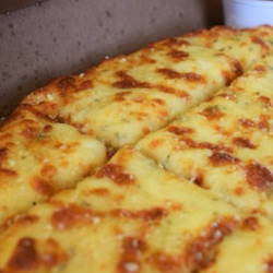 Delicious Garlic Cheese Bread Comes with pizza sauce and a Garlic Butter cup!