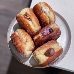 Sonrisa Donuts - Thai milk tea, strawberry pistachio, blueberry cheesecake crumble, chocolate fudge, vanilla birthday cake