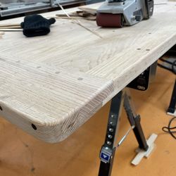 Parsons Custom Woodworking - Breadboard end of oak tabletop with MANY ebony plugs throughout the entire table along the tongue and groove joints.