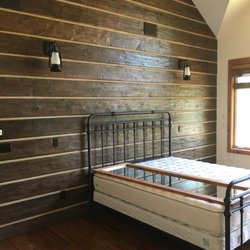 Timberline Construction - Bedroom remodel with log walls.