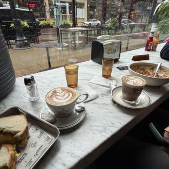 Goddess and the Baker, 33 S Wabash-Millennium Park - Morning Sandwich, cappuccino, small mocha, and Protein Bowl Barbacoa & Eggs (left to right). - Coffee & Tea Near Me - Chicago, Illinois