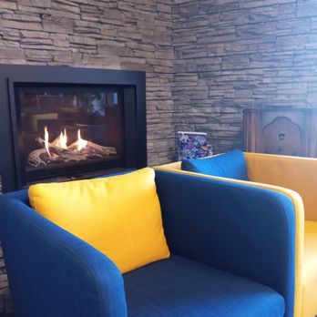 Rise Coffee - A couple of comfy chairs by the fireplace. - Coffee & Tea Near Me - Nisku, Alberta