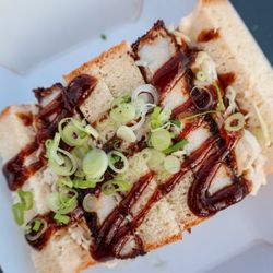 The classic Tonkatsu Sando is a pork cutlet that's breaded in panko & fried. It's then topped with katsu sauce, kewpie mayo, & koji-cabbage