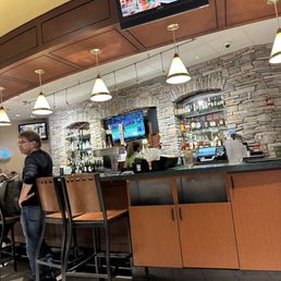 PGA Tour Grill - a man sitting at the bar - interior - Bars Near Me - Honolulu, Hawaii