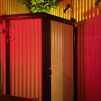 Habana Outpost - a bathroom with a red light - Cuban Near Me - Brooklyn, New York