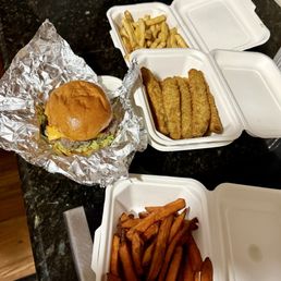 Village Burger with fries, pickle chips, and sweet potato fries