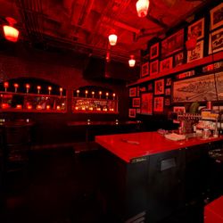 Tables and pictures at the end of the bar