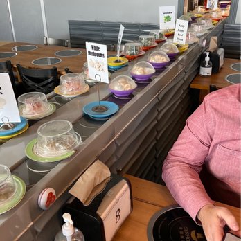 K+ Hotpot -  a woman sitting at a table with a plate of food - Hot Pot Near Me - Aurora, Colorado