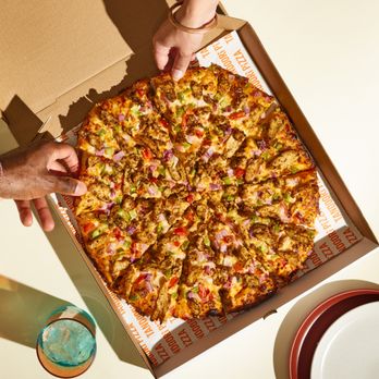 Tandoori Pizza - a person grabbing a slice of pizza - Pizza Near Me - Mountain House, California Tandoori Pizza - a person grabbing a slice of pizza - Pizza Near Me - Mountain House, California