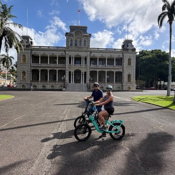 Iolani Palace - Iolani Palace with Bike Tour guests visiting the grounds - Museums Near Me - Honolulu, Hawaii
