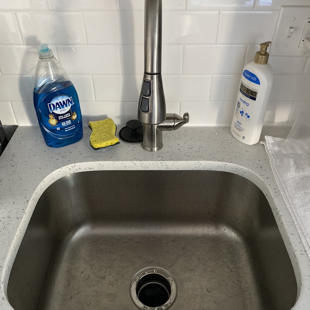 DFM Property Management - Deep stainless sink with a retractable hose sprayer at The Standard Apartment Community in the beautiful Spruce Hill area of Philadelphia. - Property Management Near Me - Philadelphia, Pennsylvania