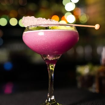 Sugar Room - The Le Bichon: Vodka, lemon citrus, butterfly pea syrup, edible reflective glitter, garnished with a rocks candy stick. - Speakeasies Near Me - Houston, Texas