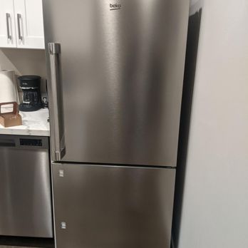 Right Water Damage - The fridge's freezer door with handle coming off - Damage Restoration Near Me