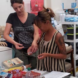 Jess, showing a student the proper way to hold the tube/needle holder.