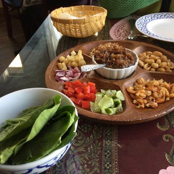 Siam House - Miang Kham ("One-bite wrap"). Roll your own spinach leaves with delicious choices of fillings. - Thai Near Me - Bloomington, Indiana Siam House - Miang Kham ("One-bite wrap"). Roll your own spinach leaves with delicious choices of fillings. - Thai Near Me - Bloomington, Indiana