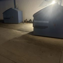 Bucharest Grill - Worker laying behind dumpster