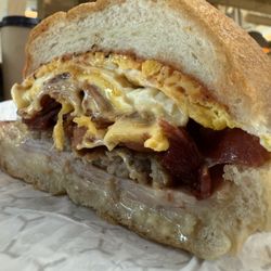 Salt Point Market and Cafe - The Gangsta $10.99 Two eggs, ham, bacon, roast beef, sausage patty, and American cheese one a roll with salt, pepper, & ketchup.