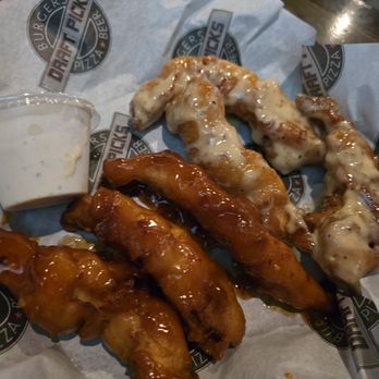 Draft Picks - Boneless Wings - Plate of boneless chicken wings with two sauces, one spicy and one creamy, served with a side of ranch dressing at Draft Picks sports bar. - Sports Bars Near Me - Mount Prospect, Illinois