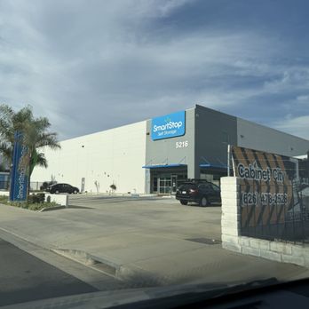 SmartStop Self Storage - Exterior - The image shows the exterior of a SmartStop Self Storage facility in San Gabriel, CA, with a large white and gray building, parking lot, and signage. - Self Storage Near Me - San Gabriel, California