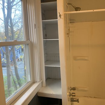 Kit Renovation - Shower and shelving before reno - General Contractors Near Me
