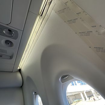 Breeze Airways - You can see the gaps where the tape has failed and only being held up in top left corner by other trim piece. - Airlines Near Me - Louisville, Kentucky Breeze Airways - You can see the gaps where the tape has failed and only being held up in top left corner by other trim piece. - Airlines Near Me - Louisville, Kentucky