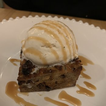 Cucciolo Osteria - Bread pudding: warm Cinnamon brioche bread topped with vanilla custard and caramel sauce - Italian Near Me - Durham, North Carolina Cucciolo Osteria - Bread pudding: warm Cinnamon brioche bread topped with vanilla custard and caramel sauce - Italian Near Me - Durham, North Carolina