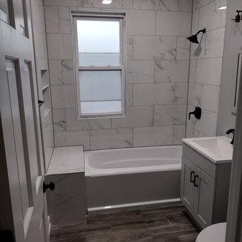 AB Home Improvements - a bathroom with a tub, toilet, and sink - Painters Near Me AB Home Improvements - a bathroom with a tub, toilet, and sink - Painters Near Me