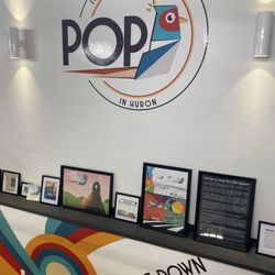 Pophuron - Entry to lower level game area, with news stories of the history behind Pop