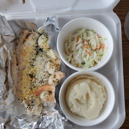 Baked seafood platter with mashed potatoes and coleslaw