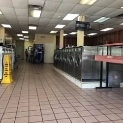 Miami Coin Laundry - Well cleaned and disinfected floors, rows of good working industrial grade washing machines. The white have a little larger barrel.