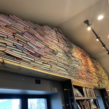 Visible Voice Books - a bookshelf in a library - Bookstores Near Me - Cleveland, Ohio