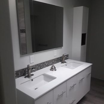Delano Construction - Wall mounted vanity with waterfall style faucets and solid surface vanity sink combo, recessed medicine cabinet/ mirror combo. - General Contractors Near Me - Tacoma, Washington Delano Construction - Wall mounted vanity with waterfall style faucets and solid surface vanity sink combo, recessed medicine cabinet/ mirror combo. - General Contractors Near Me - Tacoma, Washington