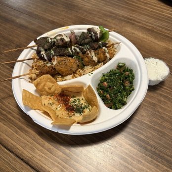 Taste Of Lebanon - Mixed platter with steak kabob, chicken kabob, and beef kabob, with rice. Hummus and homemade chips and tabbouleh salad (parsley) - Mediterranean Near Me - Eustis, Florida Taste Of Lebanon - Mixed platter with steak kabob, chicken kabob, and beef kabob, with rice. Hummus and homemade chips and tabbouleh salad (parsley) - Mediterranean Near Me - Eustis, Florida