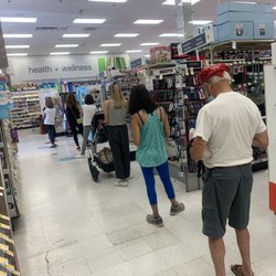 Walgreens - More than 12 people waiting in line at the pharmacy. And the line is longer than that.  There are more people behind me.